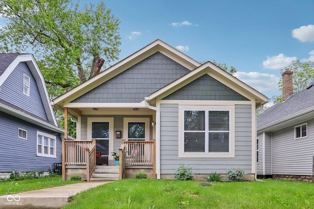 617 N Dearborn St, Indianapolis, IN 46201 - view of front of house featuring covered porch and a front lawn