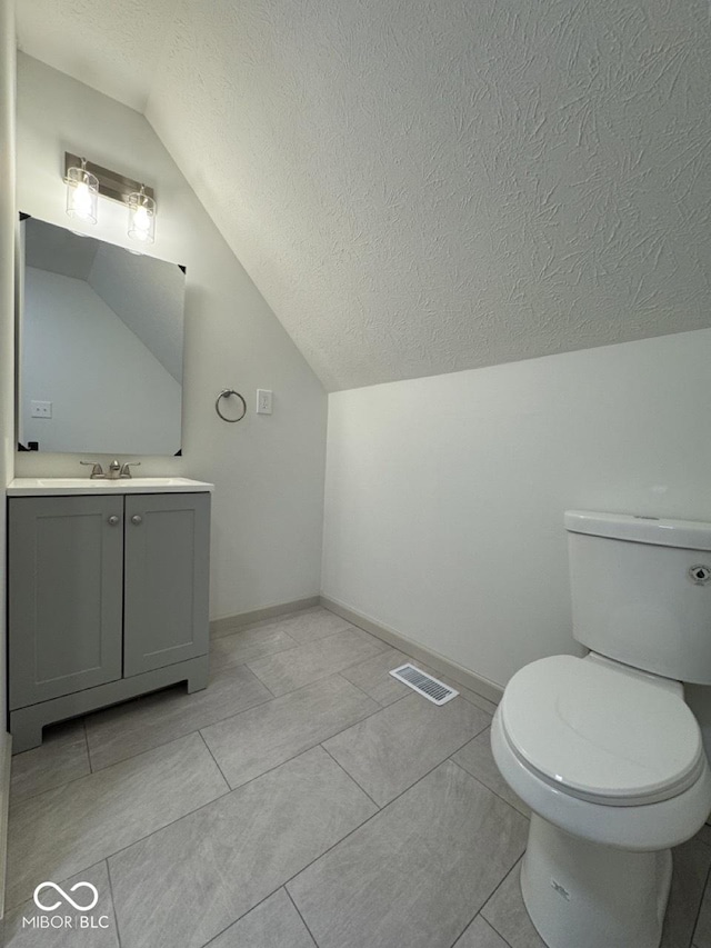 317 W Pierson St, Greenfield, IN 46140 - half bath with lofted ceiling, toilet, a textured ceiling, vanity, and baseboards