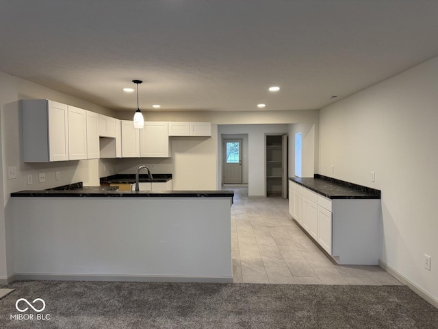 317 W Pierson St, Greenfield, IN 46140 - kitchen featuring a peninsula, recessed lighting, white cabinetry, light carpet, and a sink