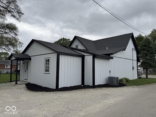 317 W Pierson St, Greenfield, IN 46140 - view of side of property featuring roof with shingles and central AC