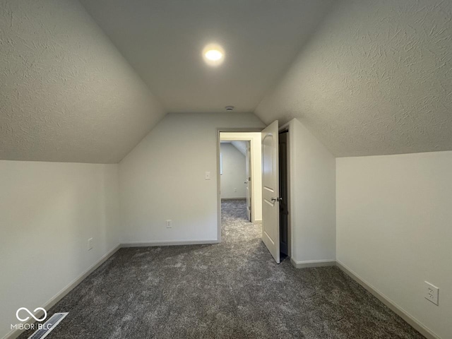 317 W Pierson St, Greenfield, IN 46140 - bonus room featuring carpet floors, lofted ceiling, a textured ceiling, and baseboards