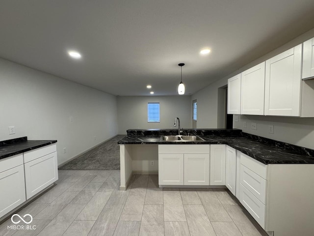 317 W Pierson St, Greenfield, IN 46140 - kitchen featuring a sink, a peninsula, recessed lighting, white cabinetry, and pendant lighting