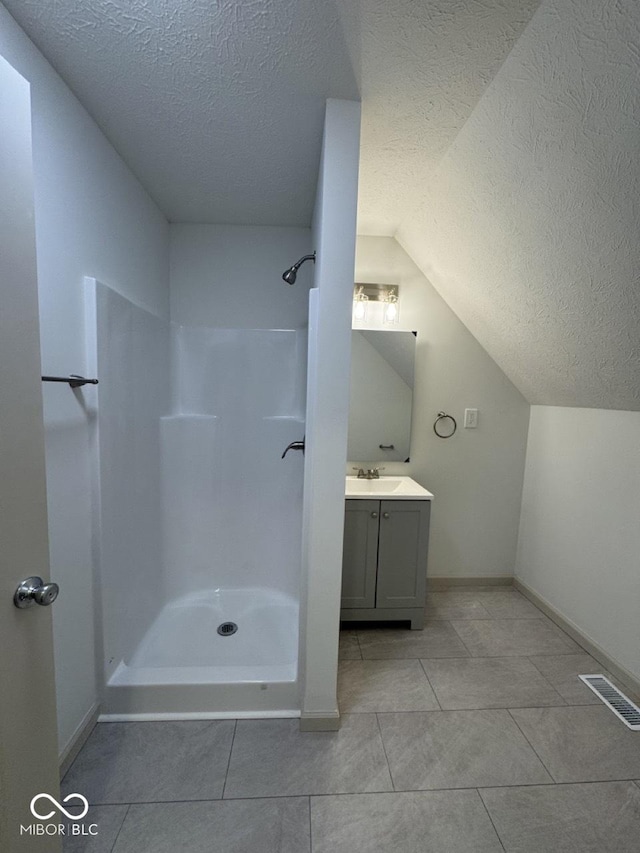 317 W Pierson St, Greenfield, IN 46140 - full bath with a textured ceiling, a shower, vanity, baseboards, and tile patterned flooring