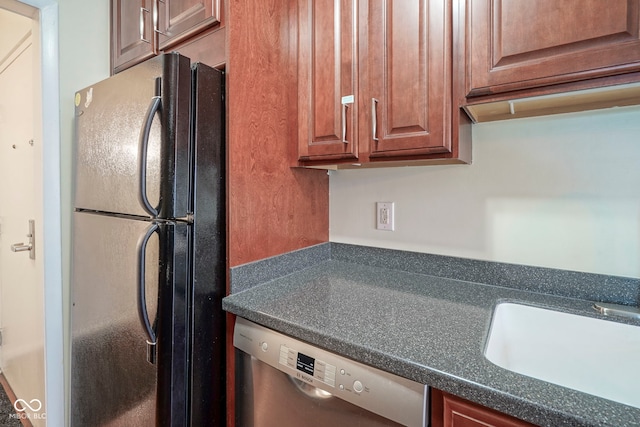 3965 N Meridian St Unit 3J, West, Indianapolis, IN 46208 - kitchen featuring freestanding refrigerator, stainless steel dishwasher, dark countertops, and a sink