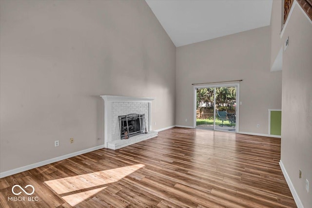8908 Sunningdale Blvd, Indianapolis, IN 46234 - unfurnished living room with high vaulted ceiling, a fireplace, and wood finished floors