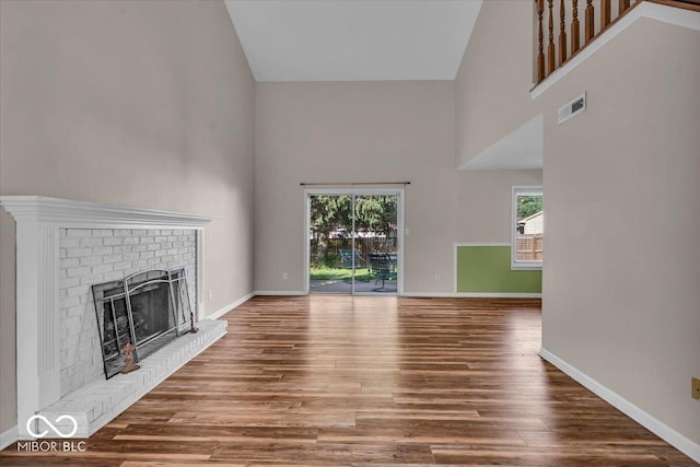 8908 Sunningdale Blvd, Indianapolis, IN 46234 - unfurnished living room with a high ceiling, a fireplace, and wood finished floors