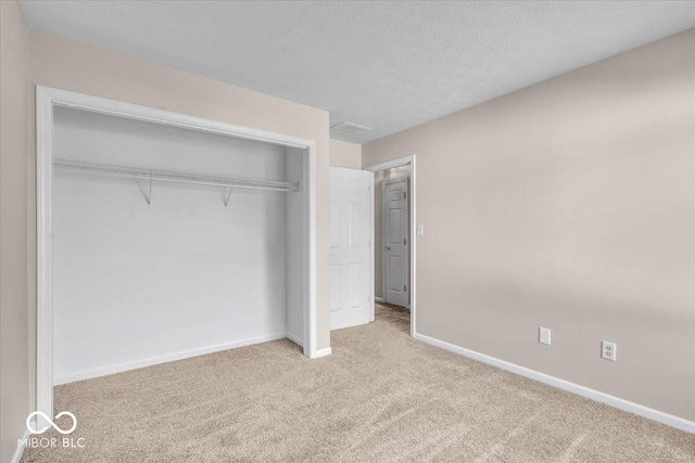 8908 Sunningdale Blvd, Indianapolis, IN 46234 - unfurnished bedroom with carpet floors, a closet, and a textured ceiling