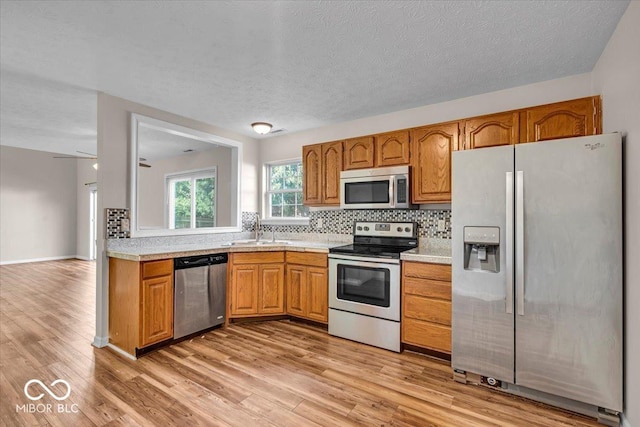 8908 Sunningdale Blvd, Indianapolis, IN 46234 - kitchen with appliances with stainless steel finishes, light countertops, backsplash, and a textured ceiling