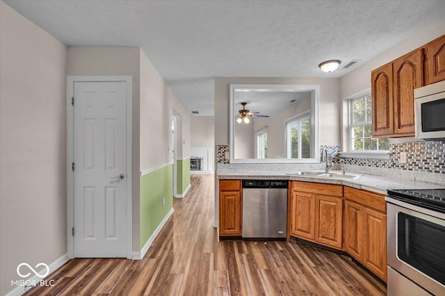 8908 Sunningdale Blvd, Indianapolis, IN 46234 - kitchen with appliances with stainless steel finishes, light countertops, dark wood-style floors, decorative backsplash, and a textured ceiling