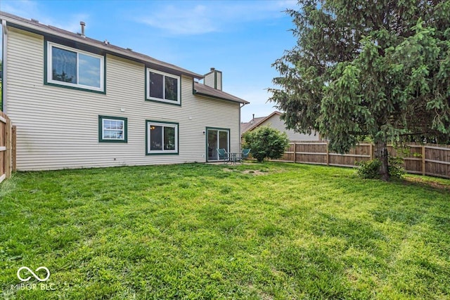 8908 Sunningdale Blvd, Indianapolis, IN 46234 - back of house with a fenced backyard and a chimney