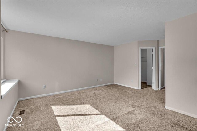 8908 Sunningdale Blvd, Indianapolis, IN 46234 - carpeted spare room featuring baseboards and a textured ceiling