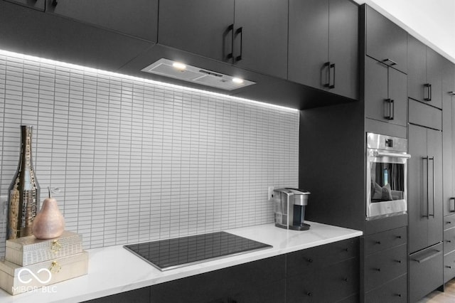 420 Monon Wy Dr, Carmel, IN 46032 - kitchen with oven, black electric cooktop, ventilation hood, and tasteful backsplash