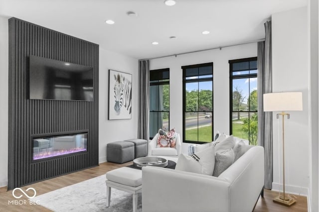 420 Monon Wy Dr, Carmel, IN 46032 - living room featuring recessed lighting, wood finished floors, baseboards, and a glass covered fireplace