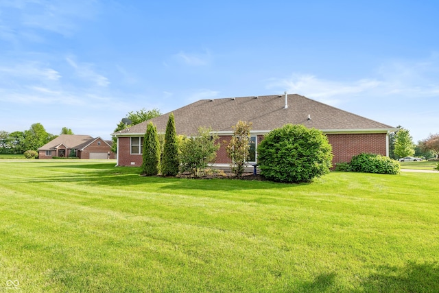 1607 Michelle Mnr, Danville, IN 46122 - rear view of property with a yard, brick siding, and a shingled roof