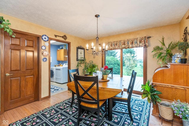 1607 Michelle Mnr, Danville, IN 46122 - dining room featuring separate washer and dryer, light wood-style flooring, and a chandelier