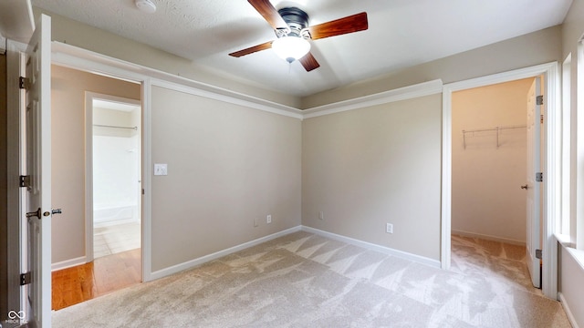 3959 Towhees Dr, Indianapolis, IN 46237 - unfurnished bedroom featuring a spacious closet, light colored carpet, baseboards, and a ceiling fan