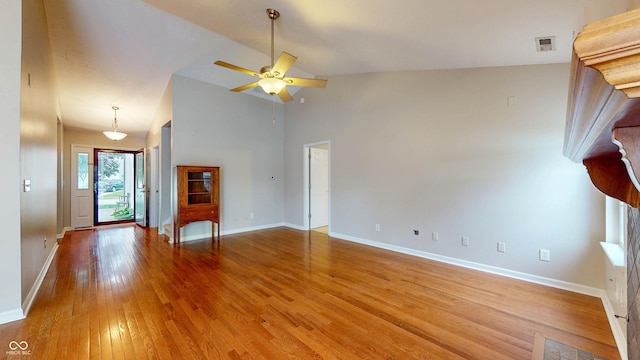 3959 Towhees Dr, Indianapolis, IN 46237 - unfurnished living room featuring light wood finished floors, a ceiling fan, baseboards, and high vaulted ceiling