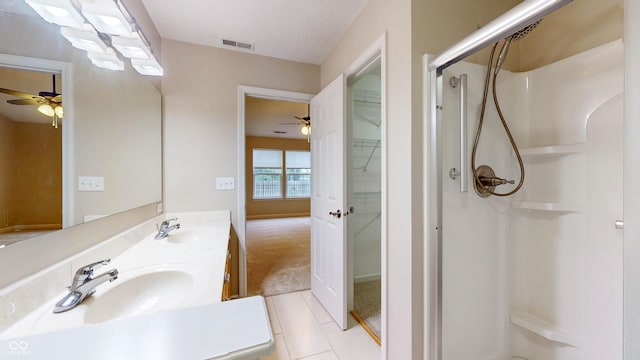 3959 Towhees Dr, Indianapolis, IN 46237 - bathroom with ceiling fan, a shower stall, tile patterned flooring, and double vanity