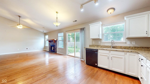3959 Towhees Dr, Indianapolis, IN 46237 - kitchen with dishwasher, a sink, light wood-style flooring, open floor plan, and a fireplace with flush hearth