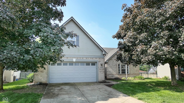 3959 Towhees Dr, Indianapolis, IN 46237 - view of front facade featuring brick siding, concrete driveway, and a garage