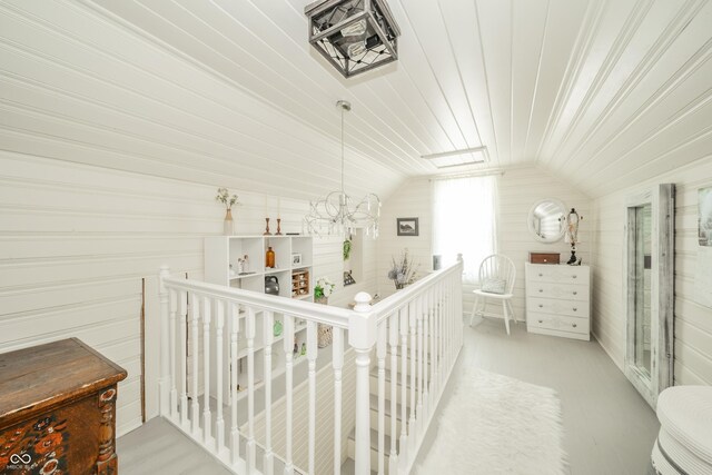 311 Northshore Blvd, Anderson, IN 46011 - hall with an upstairs landing, vaulted ceiling, wood ceiling, a chandelier, and wood walls