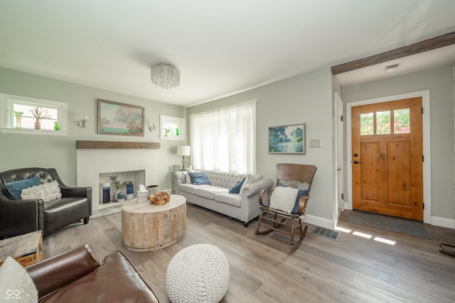 311 Northshore Blvd, Anderson, IN 46011 - living room with wood finished floors, baseboards, and a brick fireplace