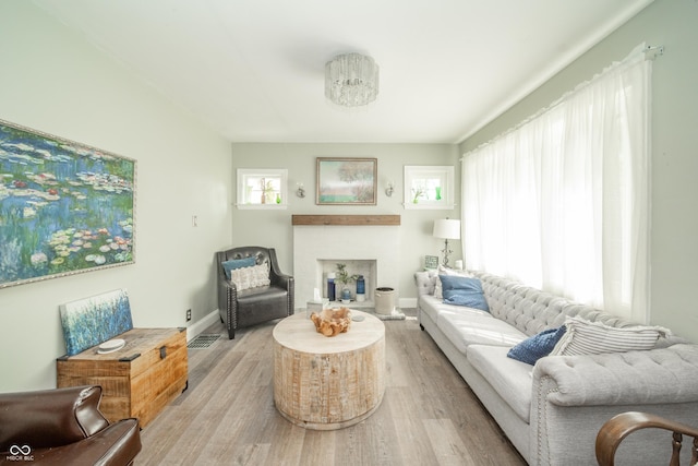 311 Northshore Blvd, Anderson, IN 46011 - living area featuring wood finished floors, a fireplace with raised hearth, and baseboards