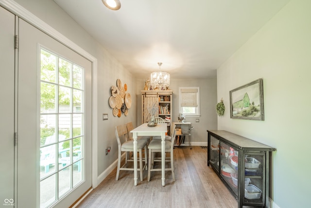 311 Northshore Blvd, Anderson, IN 46011 - dining room featuring baseboards, light wood-style floors, and a chandelier