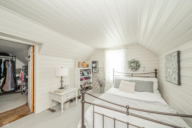 311 Northshore Blvd, Anderson, IN 46011 - bedroom featuring a walk in closet, lofted ceiling, a closet, wooden walls, and wooden ceiling
