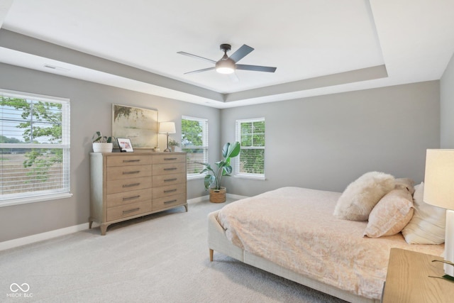 17551 Gruner Way, Westfield, IN 46062 - bedroom with a tray ceiling, baseboards, light colored carpet, and a ceiling fan
