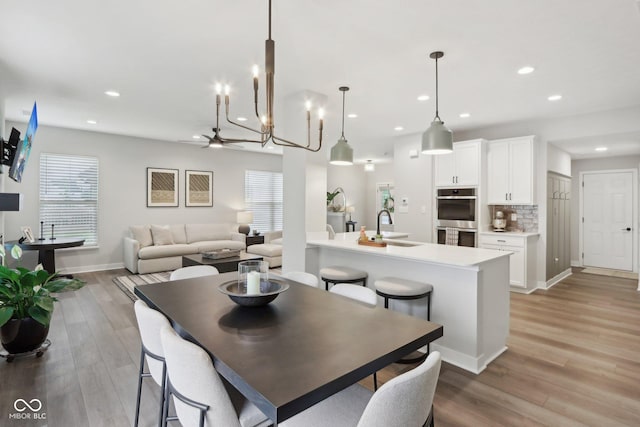 17551 Gruner Way, Westfield, IN 46062 - dining room featuring recessed lighting, light wood-style flooring, a chandelier, baseboards, and ceiling fan