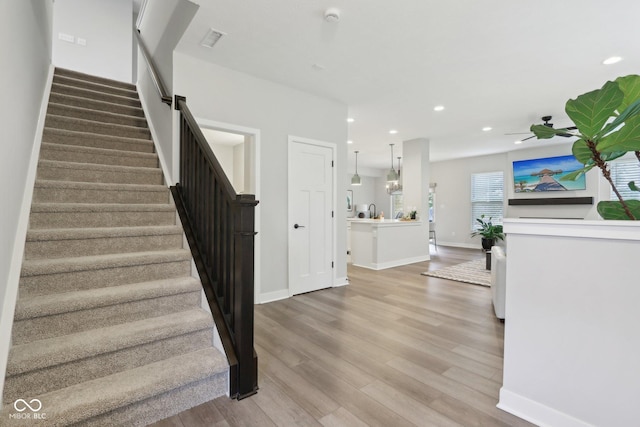 17551 Gruner Way, Westfield, IN 46062 - stairs featuring wood finished floors, recessed lighting, a ceiling fan, and baseboards