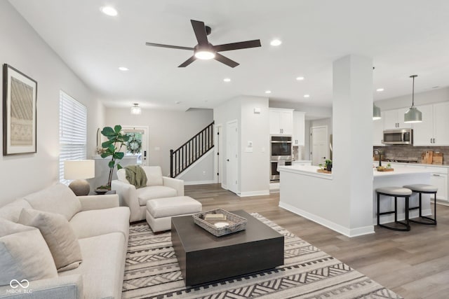 17551 Gruner Way, Westfield, IN 46062 - living area with stairs, light wood-style flooring, ceiling fan, recessed lighting, and baseboards