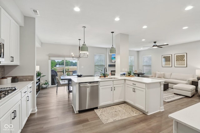 17551 Gruner Way, Westfield, IN 46062 - kitchen with appliances with stainless steel finishes, a sink, open floor plan, recessed lighting, and light countertops