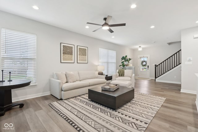 17551 Gruner Way, Westfield, IN 46062 - living area featuring stairway, a ceiling fan, plenty of natural light, wood finished floors, and recessed lighting