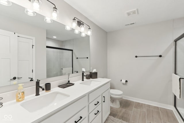17551 Gruner Way, Westfield, IN 46062 - bathroom featuring a stall shower, double vanity, toilet, and baseboards