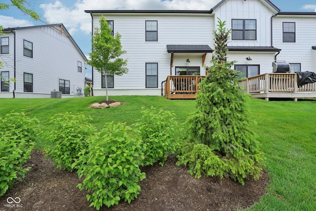 17551 Gruner Way, Westfield, IN 46062 - back of house featuring a wooden deck, board and batten siding, a lawn, and central air condition unit