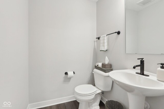 17551 Gruner Way, Westfield, IN 46062 - bathroom with baseboards, wood finished floors, toilet, and a sink