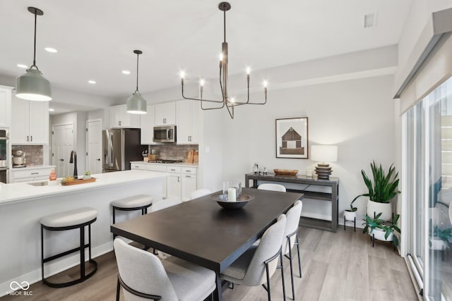 17551 Gruner Way, Westfield, IN 46062 - dining room with light wood-style floors, recessed lighting, and a chandelier