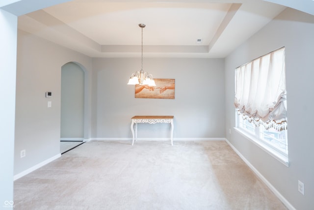 1661 Devonshire Ave, Avon, IN 46123 - spare room with a raised ceiling, arched walkways, carpet, and baseboards