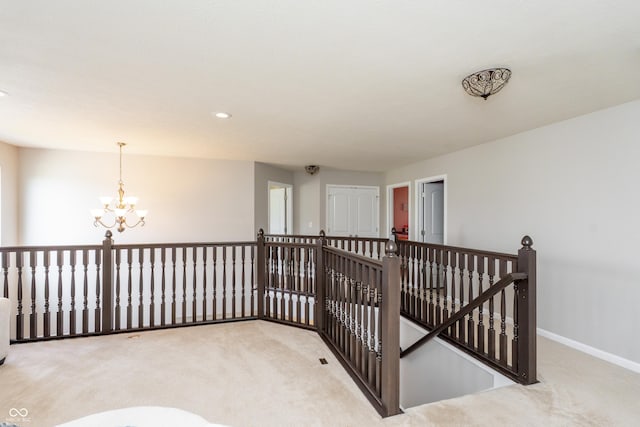 1661 Devonshire Ave, Avon, IN 46123 - corridor with carpet floors, an upstairs landing, a chandelier, baseboards, and recessed lighting