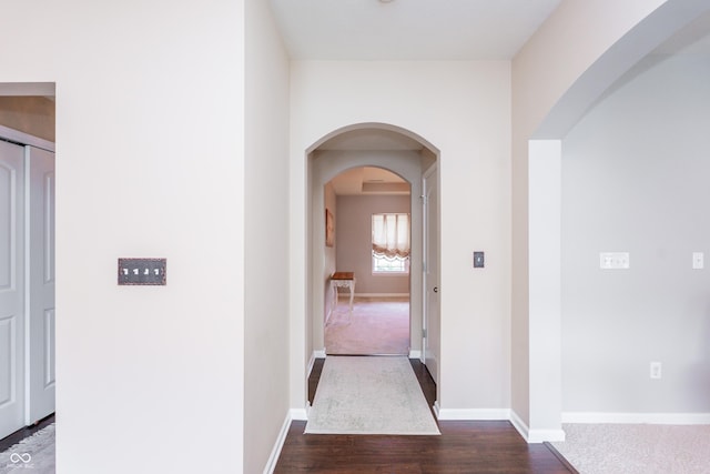 1661 Devonshire Ave, Avon, IN 46123 - hallway featuring dark wood finished floors, baseboards, and arched walkways