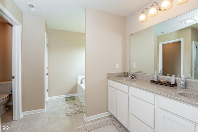 1661 Devonshire Ave, Avon, IN 46123 - full bath featuring toilet, double vanity, a bath, and baseboards