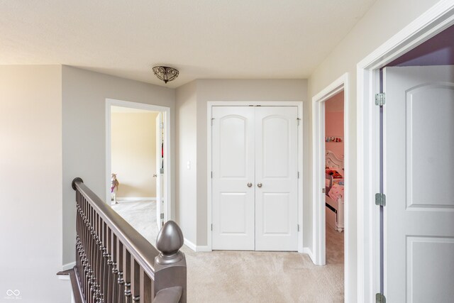 1661 Devonshire Ave, Avon, IN 46123 - hall with an upstairs landing, carpet, and baseboards