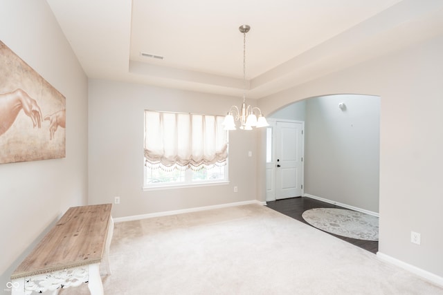 1661 Devonshire Ave, Avon, IN 46123 - entryway with a chandelier, carpet, arched walkways, a raised ceiling, and baseboards