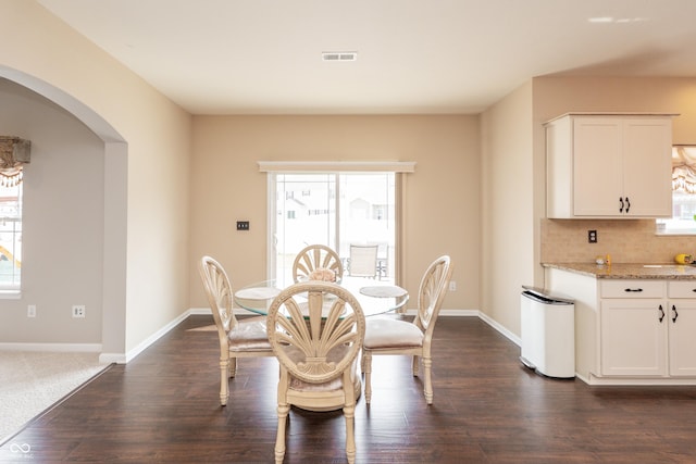 1661 Devonshire Ave, Avon, IN 46123 - dining space featuring arched walkways, dark wood-type flooring, and baseboards