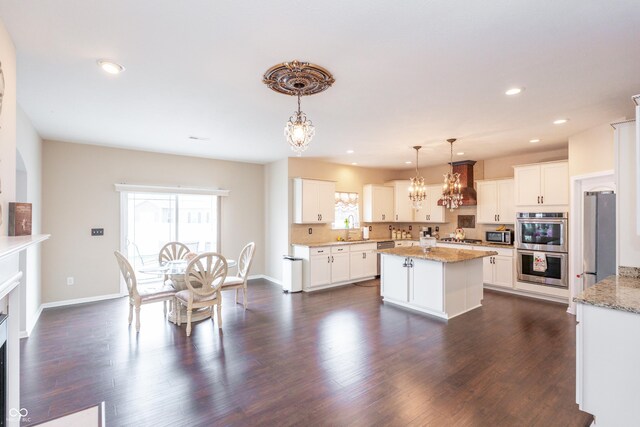 1661 Devonshire Ave, Avon, IN 46123 - kitchen featuring a chandelier, appliances with stainless steel finishes, recessed lighting, a center island, and custom exhaust hood