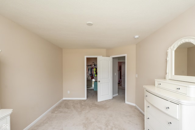 1661 Devonshire Ave, Avon, IN 46123 - unfurnished bedroom with light carpet, baseboards, and a spacious closet
