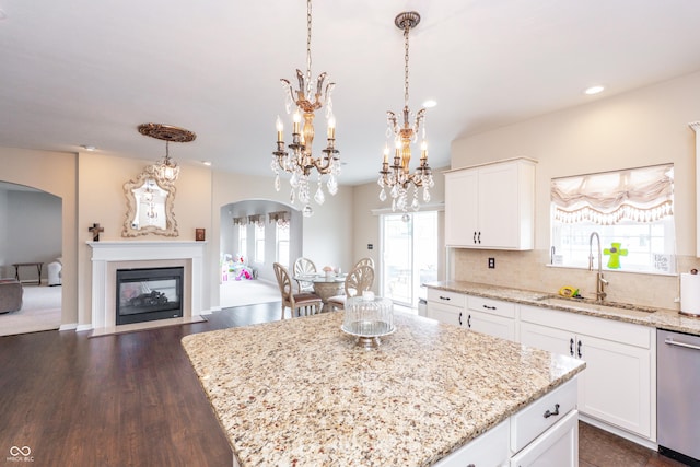 1661 Devonshire Ave, Avon, IN 46123 - kitchen featuring a sink, stainless steel dishwasher, arched walkways, healthy amount of natural light, and recessed lighting