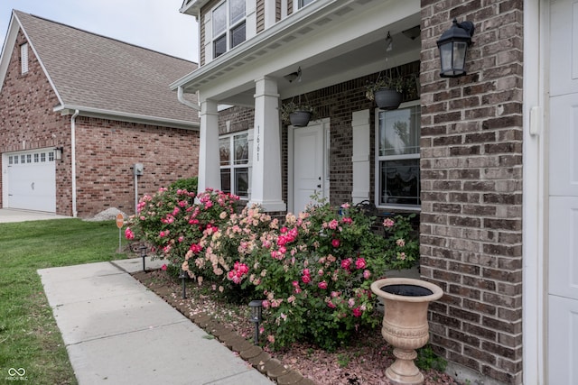 1661 Devonshire Ave, Avon, IN 46123 - property entrance with brick siding, roof with shingles, an attached garage, and covered porch